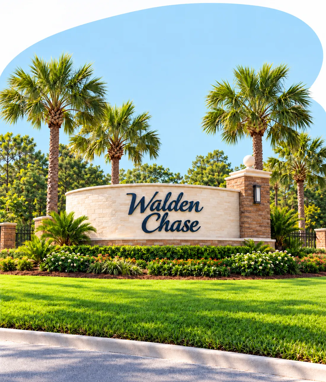 The Walden Chase entrance wall with its navy lettering and brick column, framed by palm trees and flower beds